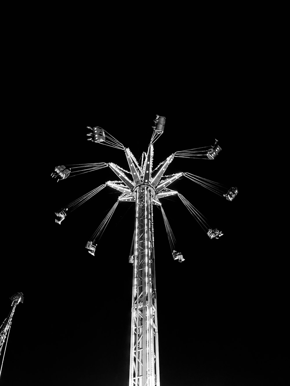 a black and white photo of a ferris wheel