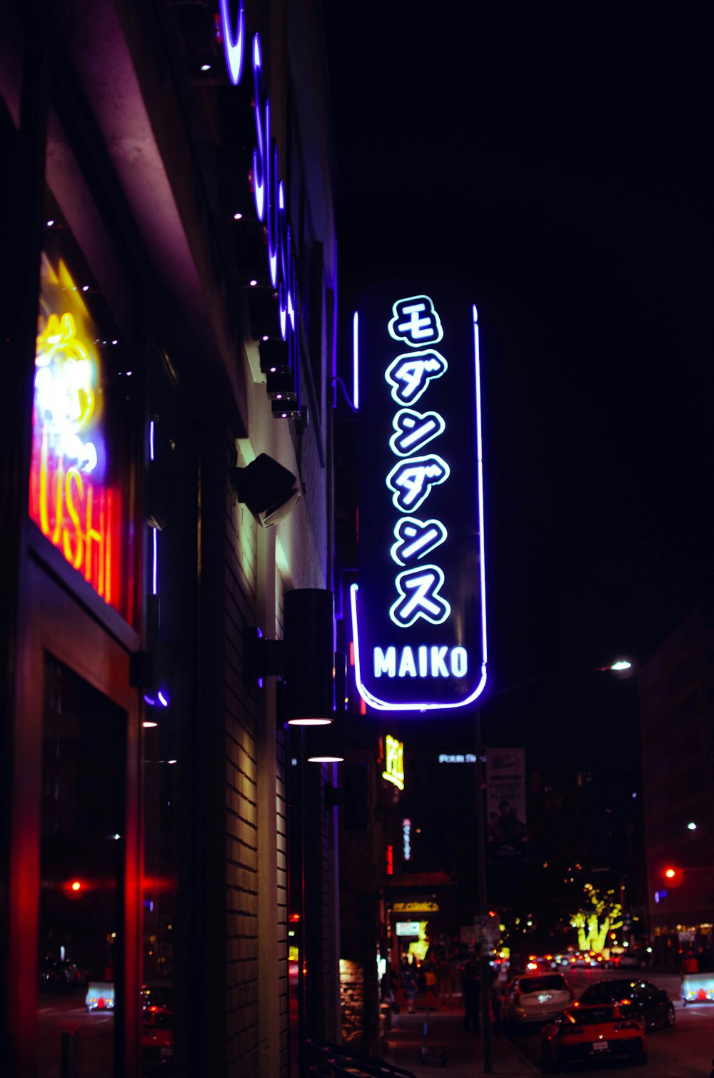 a neon sign on the side of a building