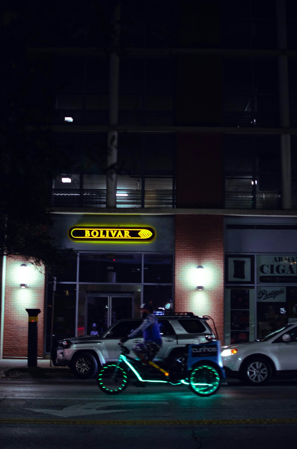 a person riding a motorcycle on a city street at night