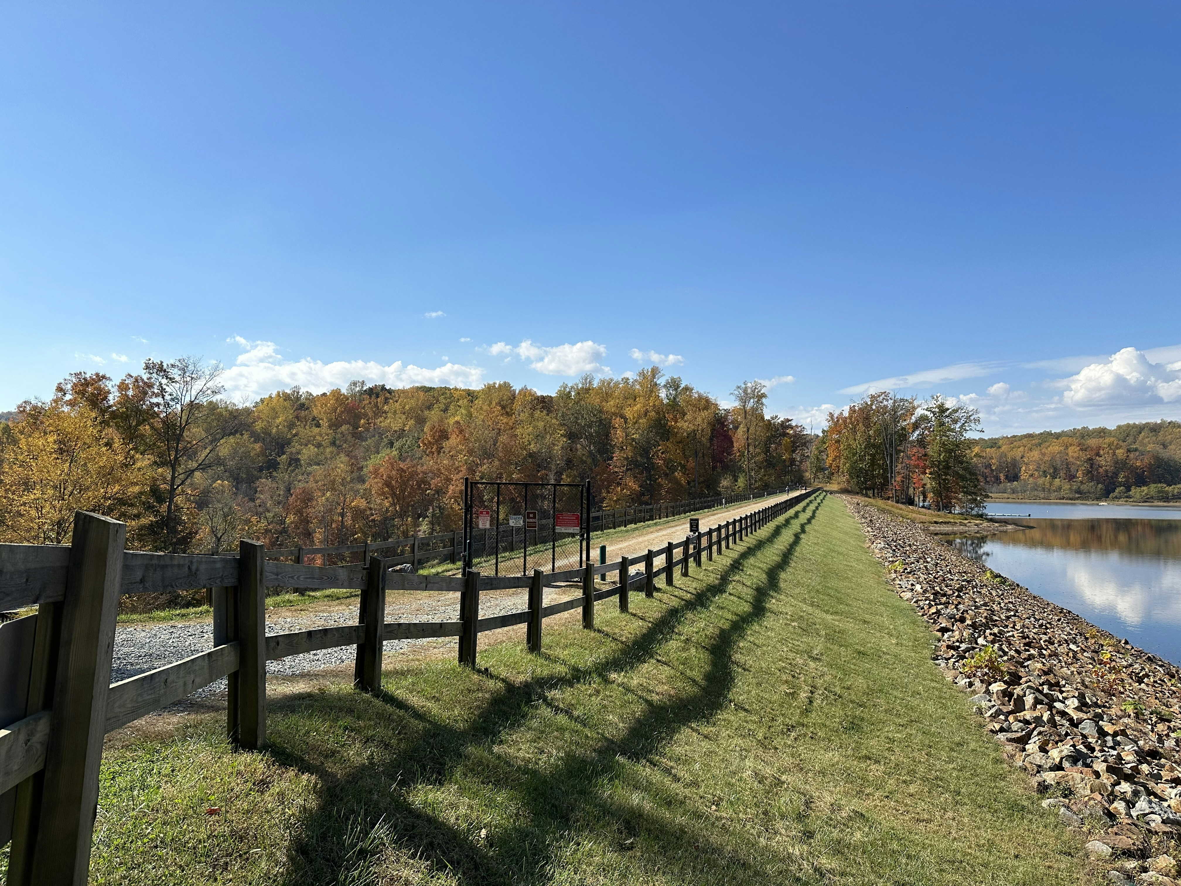 a wooden fence next to a body of water