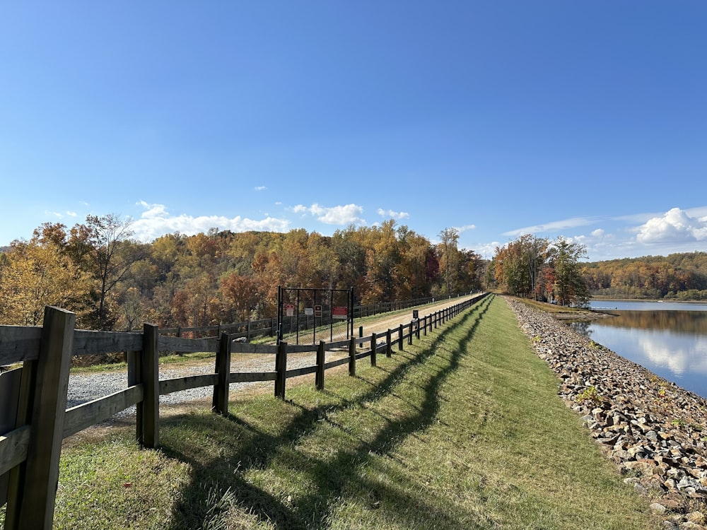 a wooden fence next to a body of water