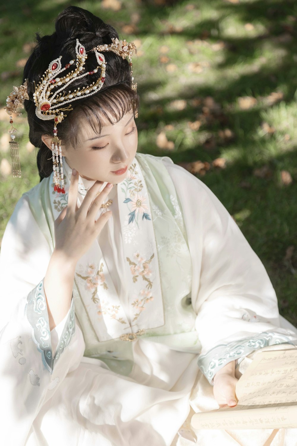 a woman in a white dress sitting on a bench