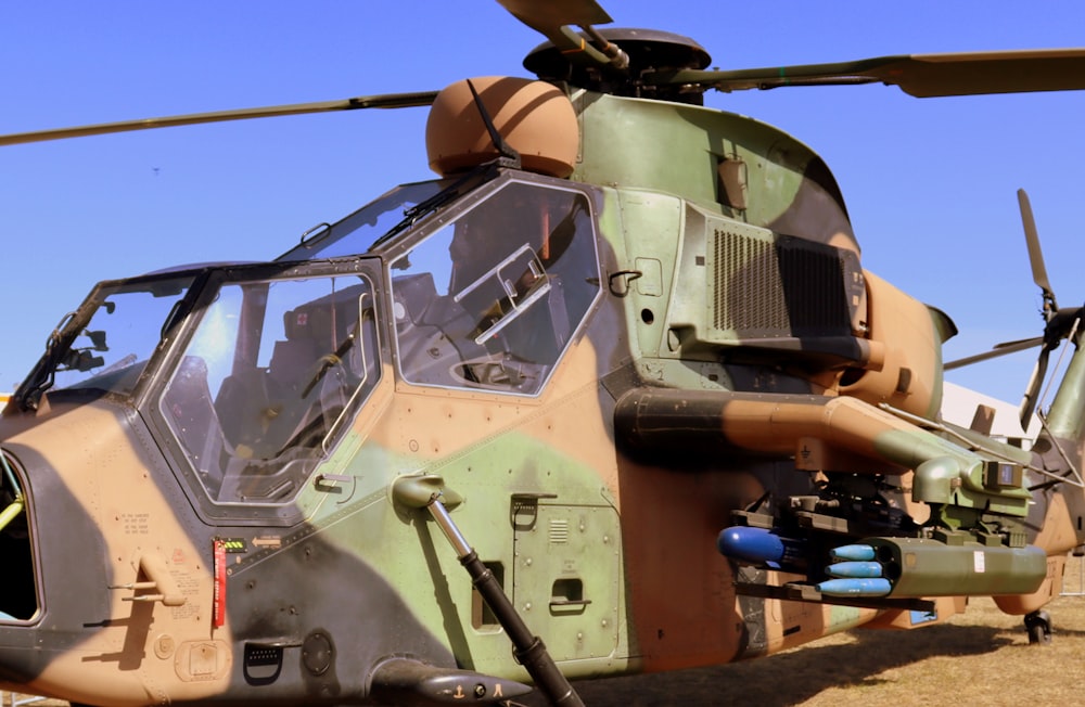 a close up of a military helicopter on a field