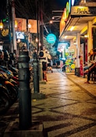 Vibrant street food scene in Saigon with colorful stalls and locals enjoying fresh dishes.