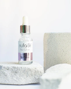 A bottle of hydrating blue-tinted facial serum with a dropper.