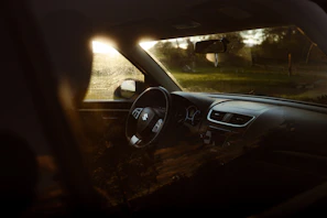 Close-up of a sparkling clean car dashboard with sunlight highlighting the details
