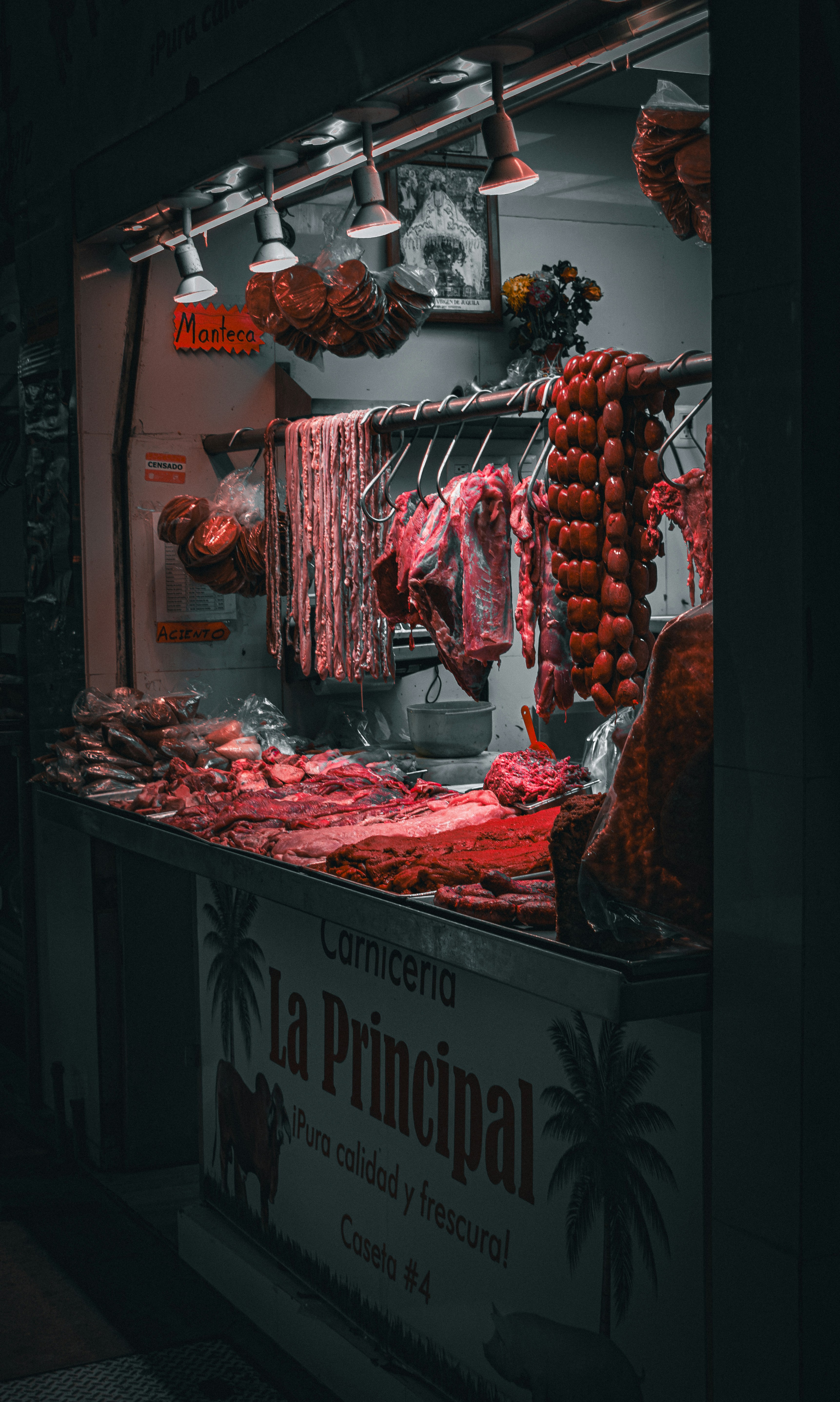 Fresh red meat cuts laid on wooden butcher block, bright natural light, artisan butchery setting
