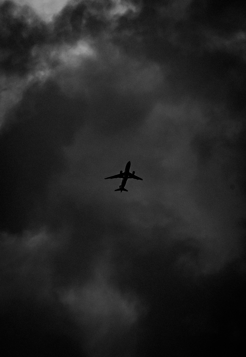 an airplane is flying through a cloudy sky