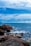 a large body of water sitting next to a rocky shore