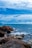 a large body of water sitting next to a rocky shore