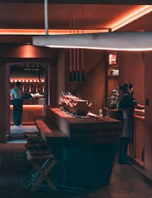 a man standing in a kitchen next to a counter