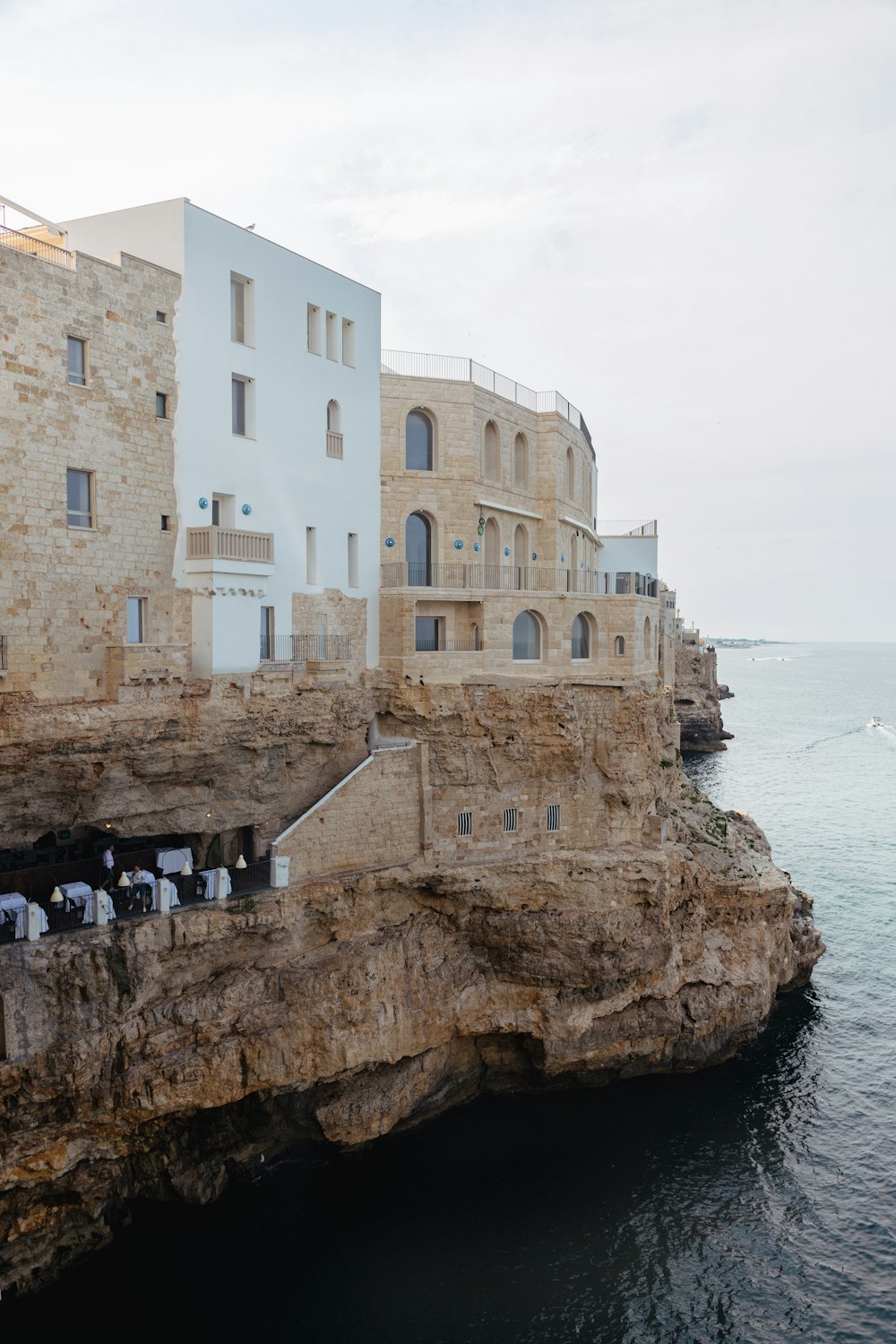 a group of people standing on the edge of a cliff