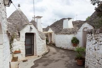 a cobblestone street lined with white stone buildings