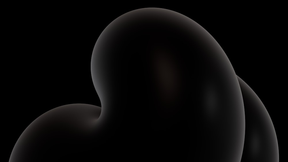 a black background with a black object in the middle