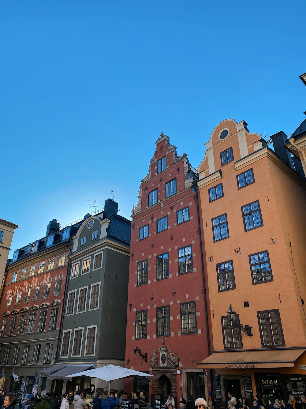 a group of buildings with people walking around them