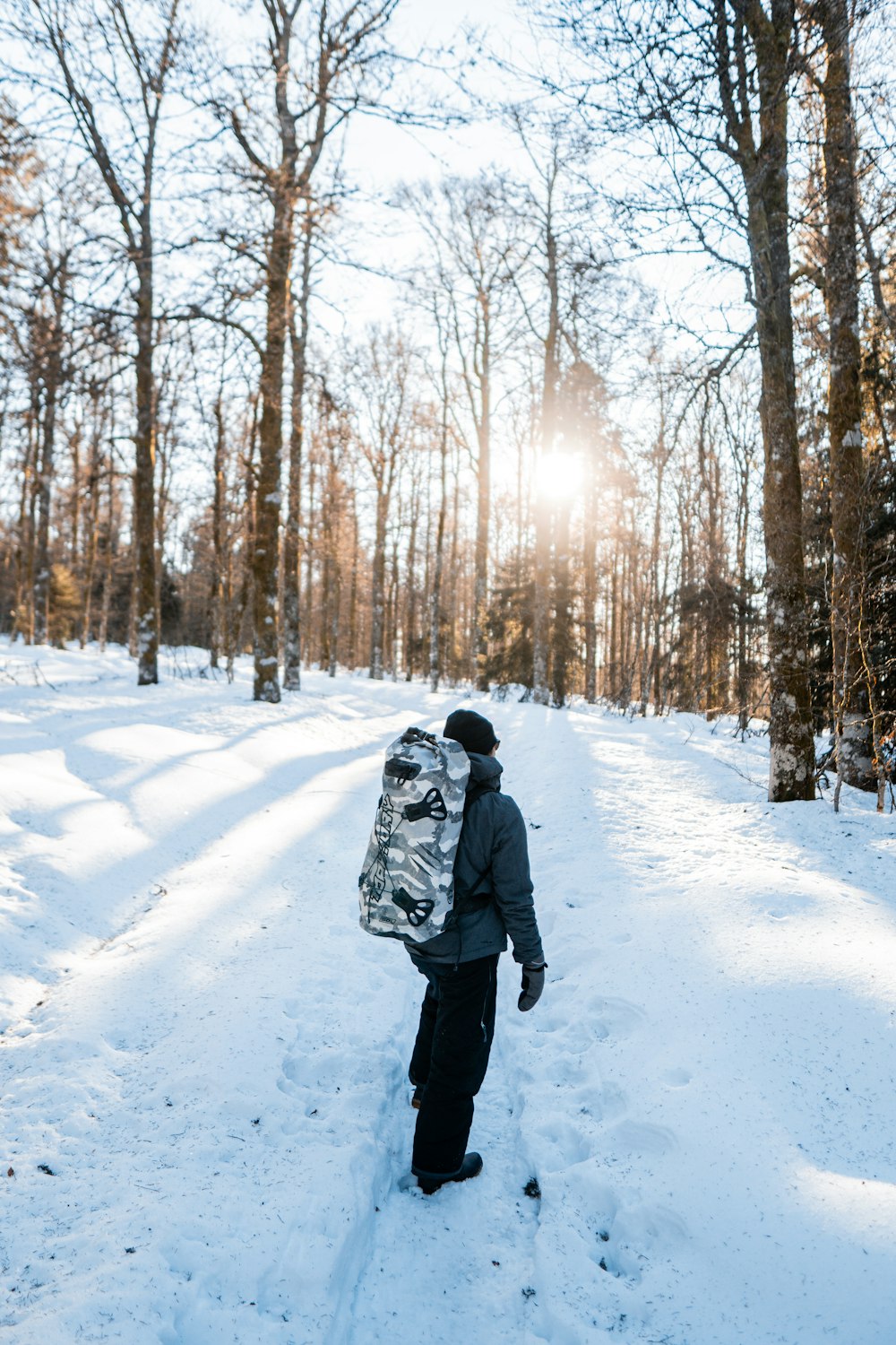 a person walking in the snow with a backpack