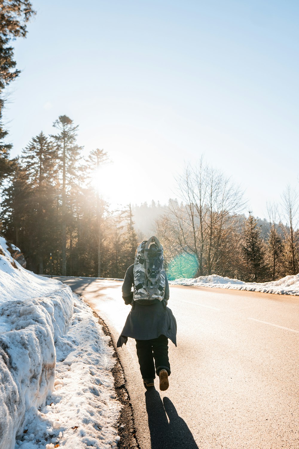 a person walking down a road with a backpack