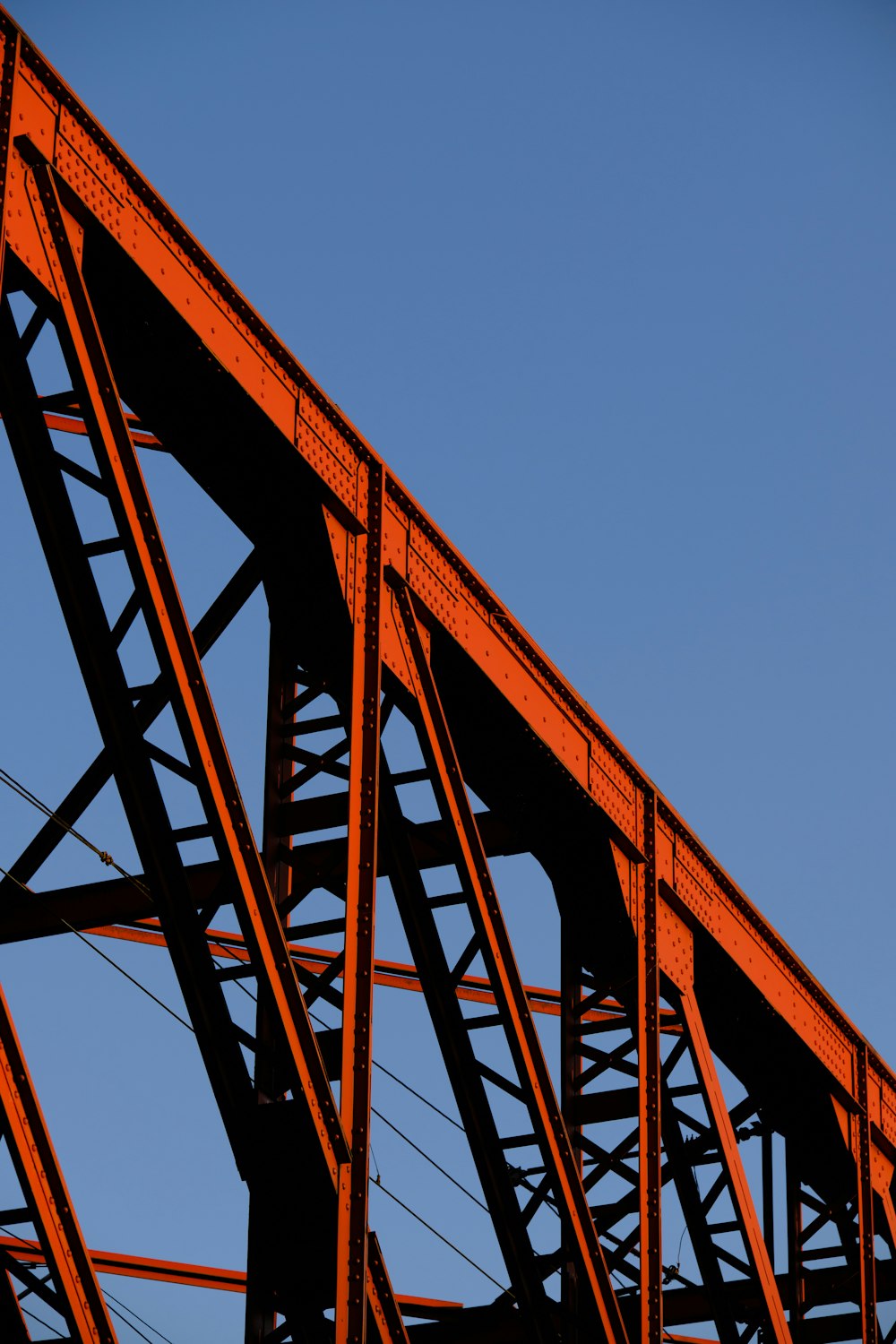 an airplane is flying over a red bridge