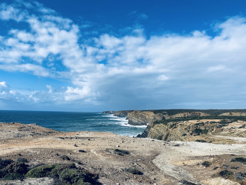 a view of the ocean from the top of a hill