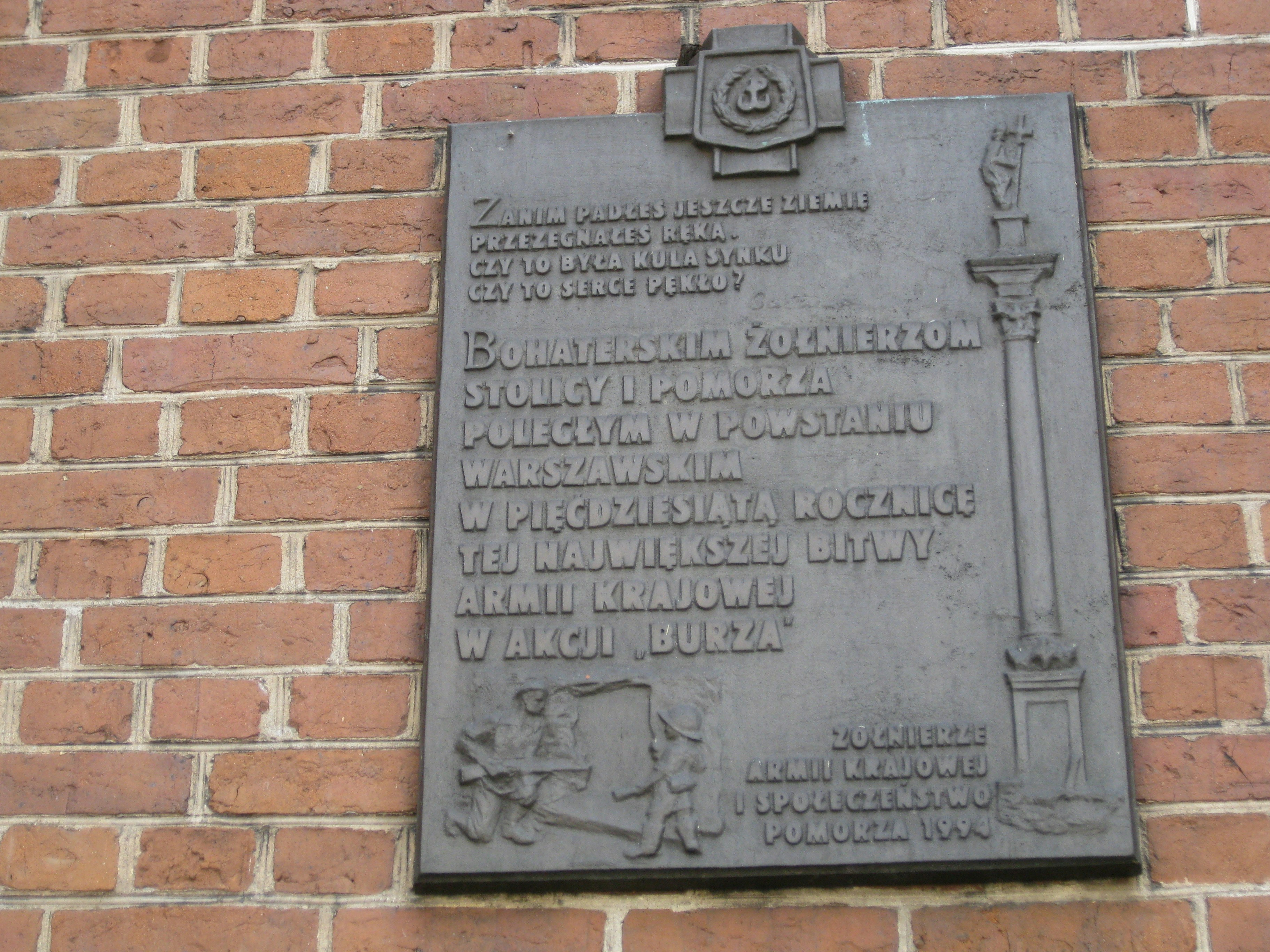 a plaque on the side of a brick building