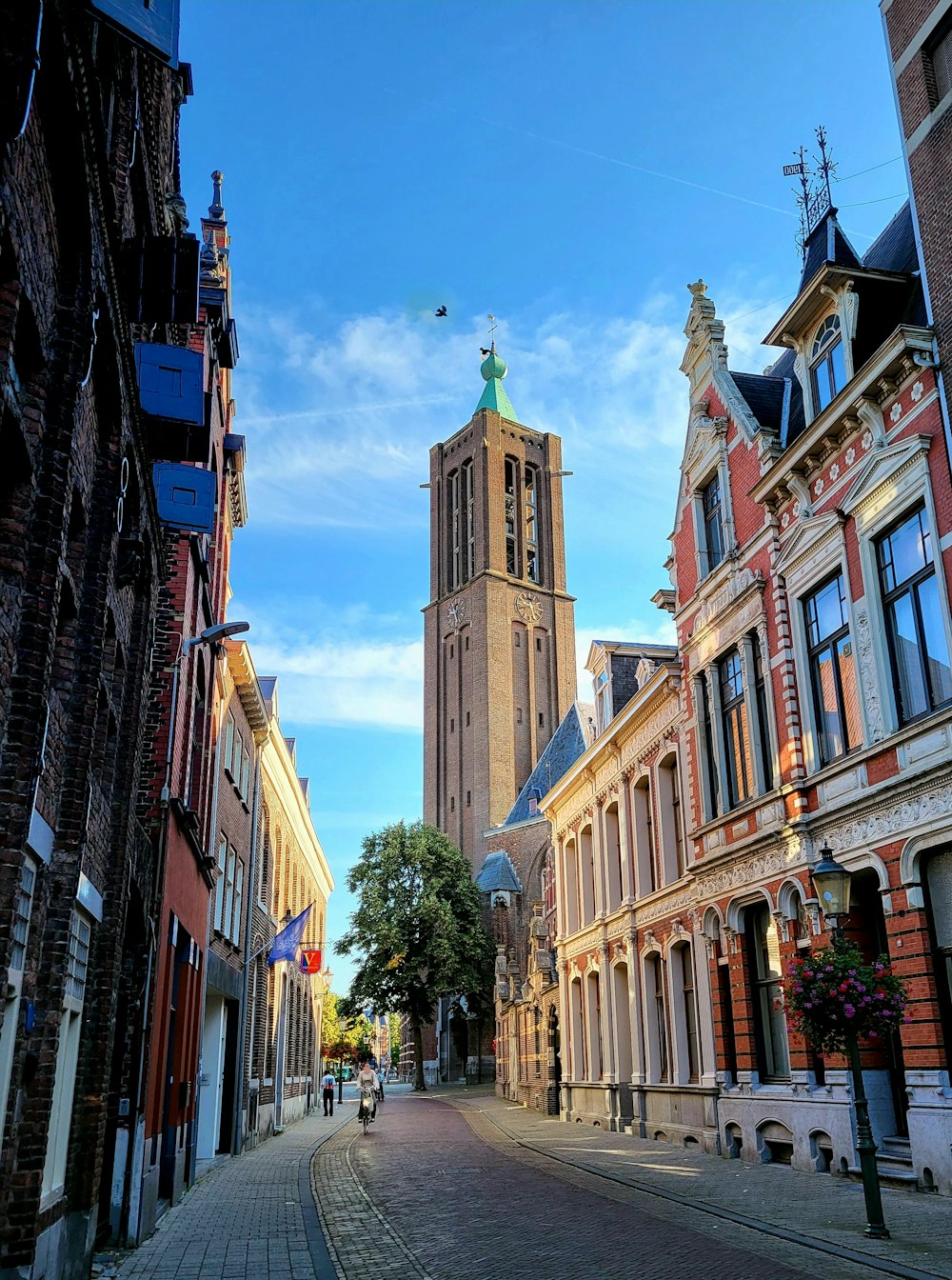 a clock tower towering over a city street