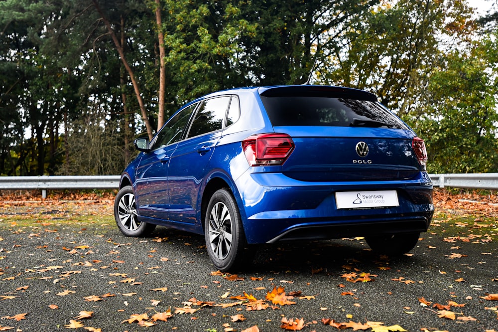 a blue car parked on the side of a road