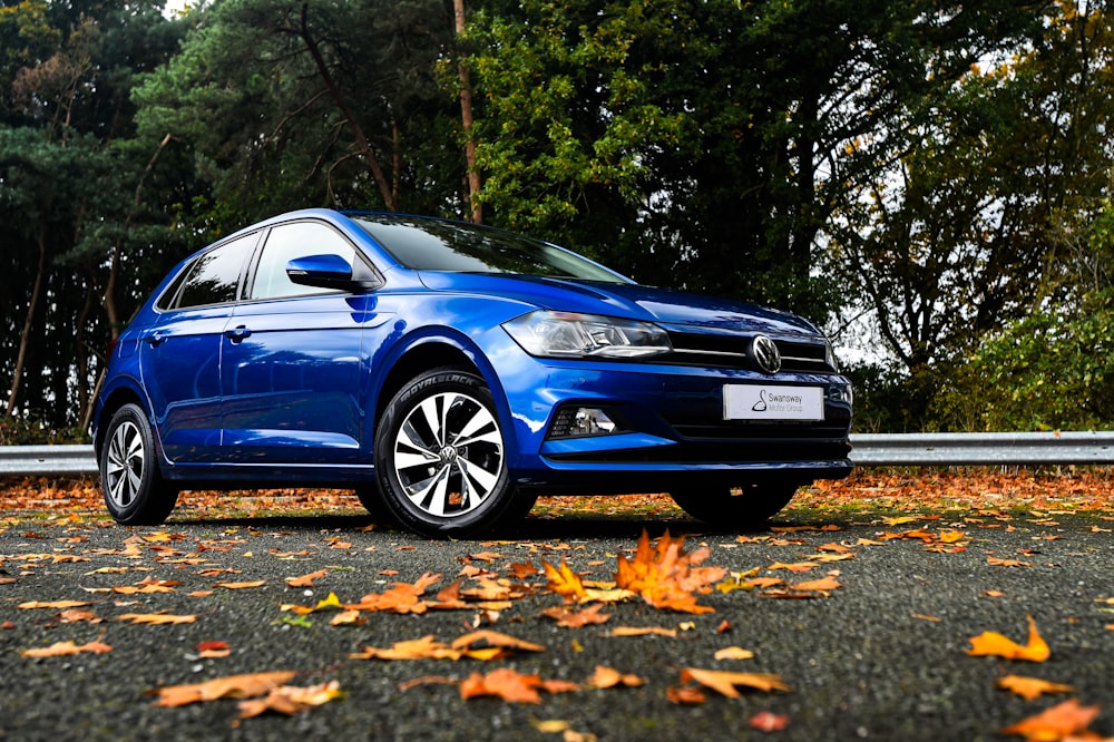 a blue car parked on the side of a road