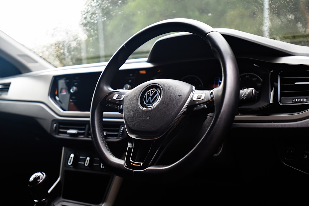 the interior of a car with a steering wheel and dashboard