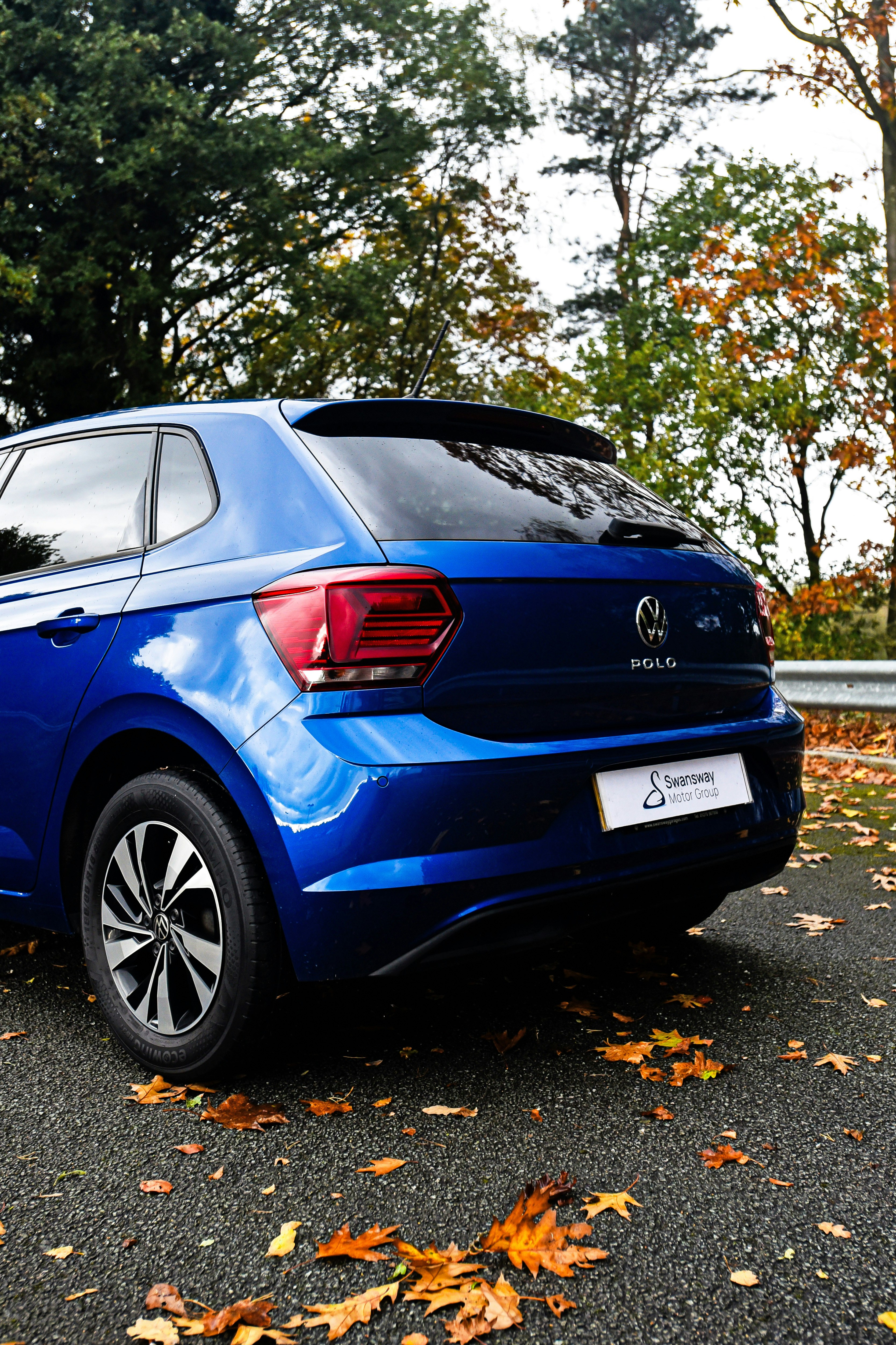 a blue car parked on the side of the road