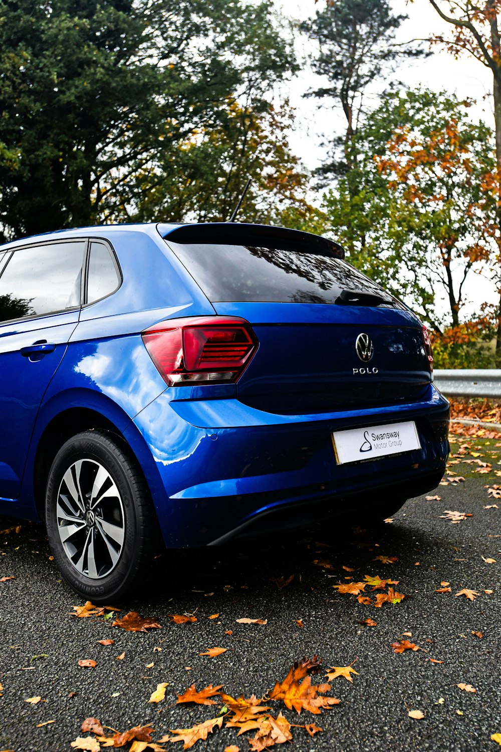 a blue car parked on the side of the road