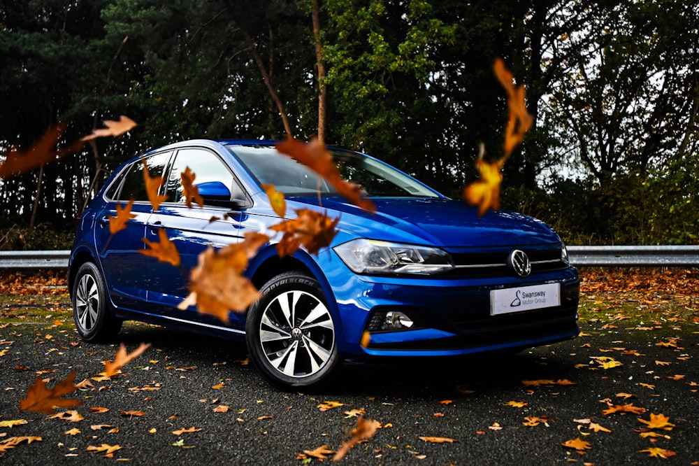 a blue car parked on the side of a road