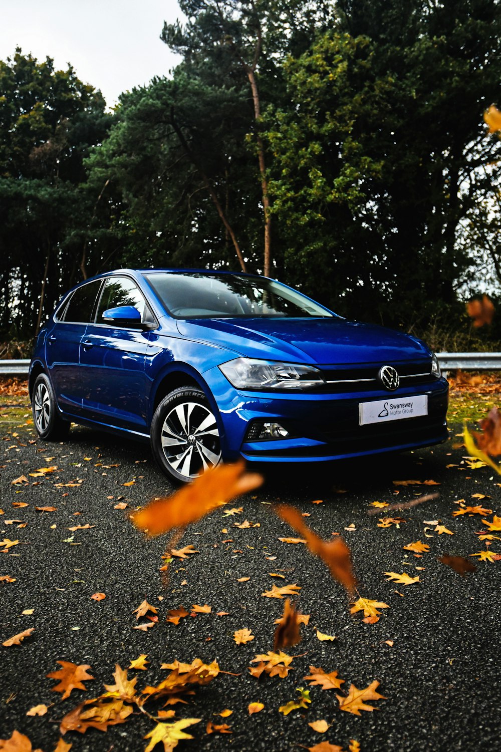 a blue car parked on the side of a road