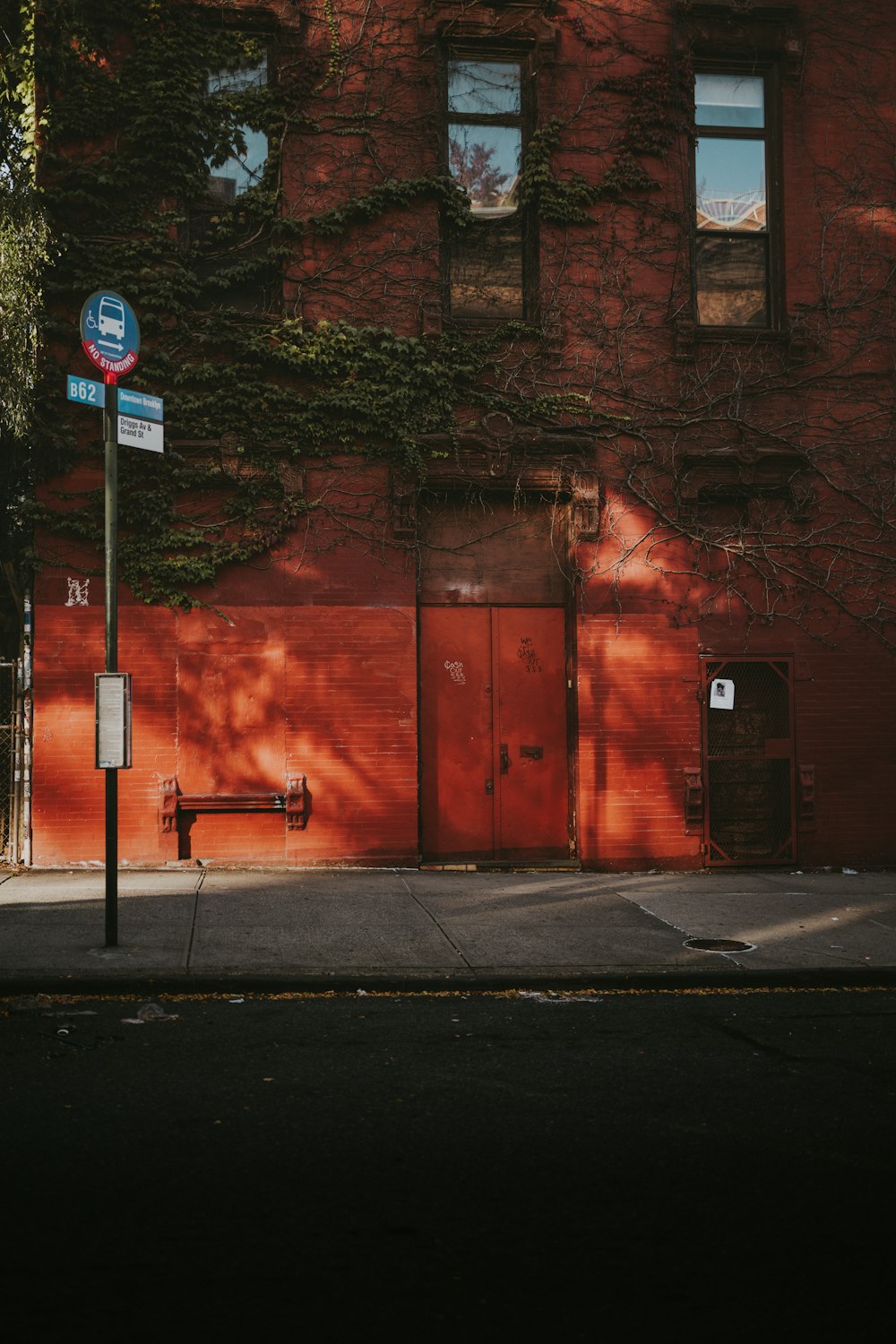 a red brick building with a street sign in front of it