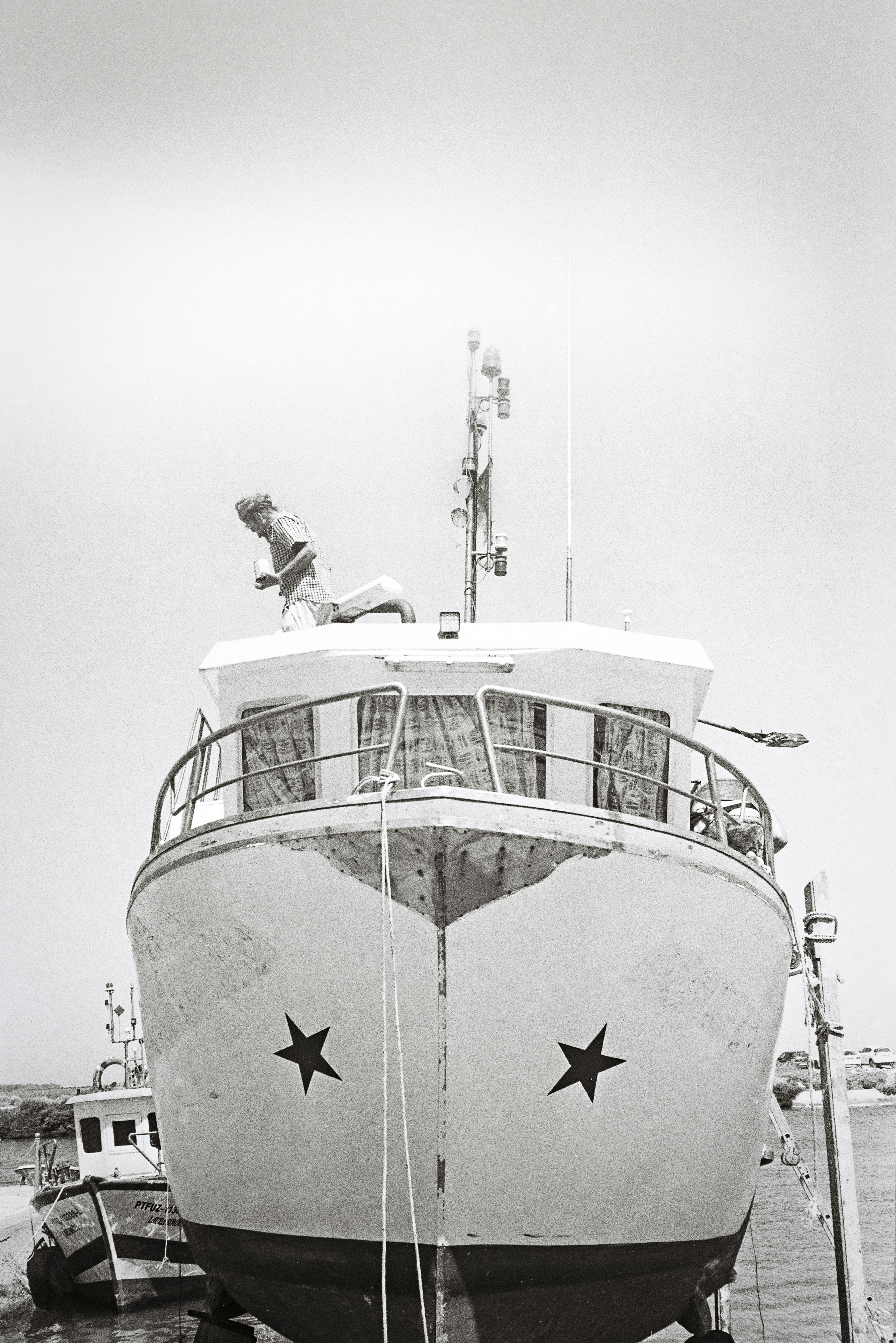 a large boat docked at a pier with people on it