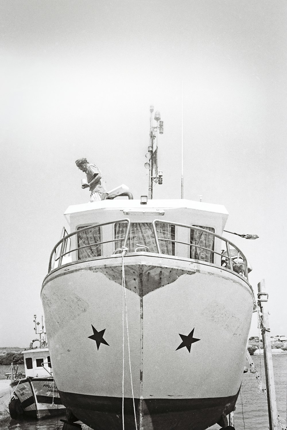 a large boat docked at a pier with people on it