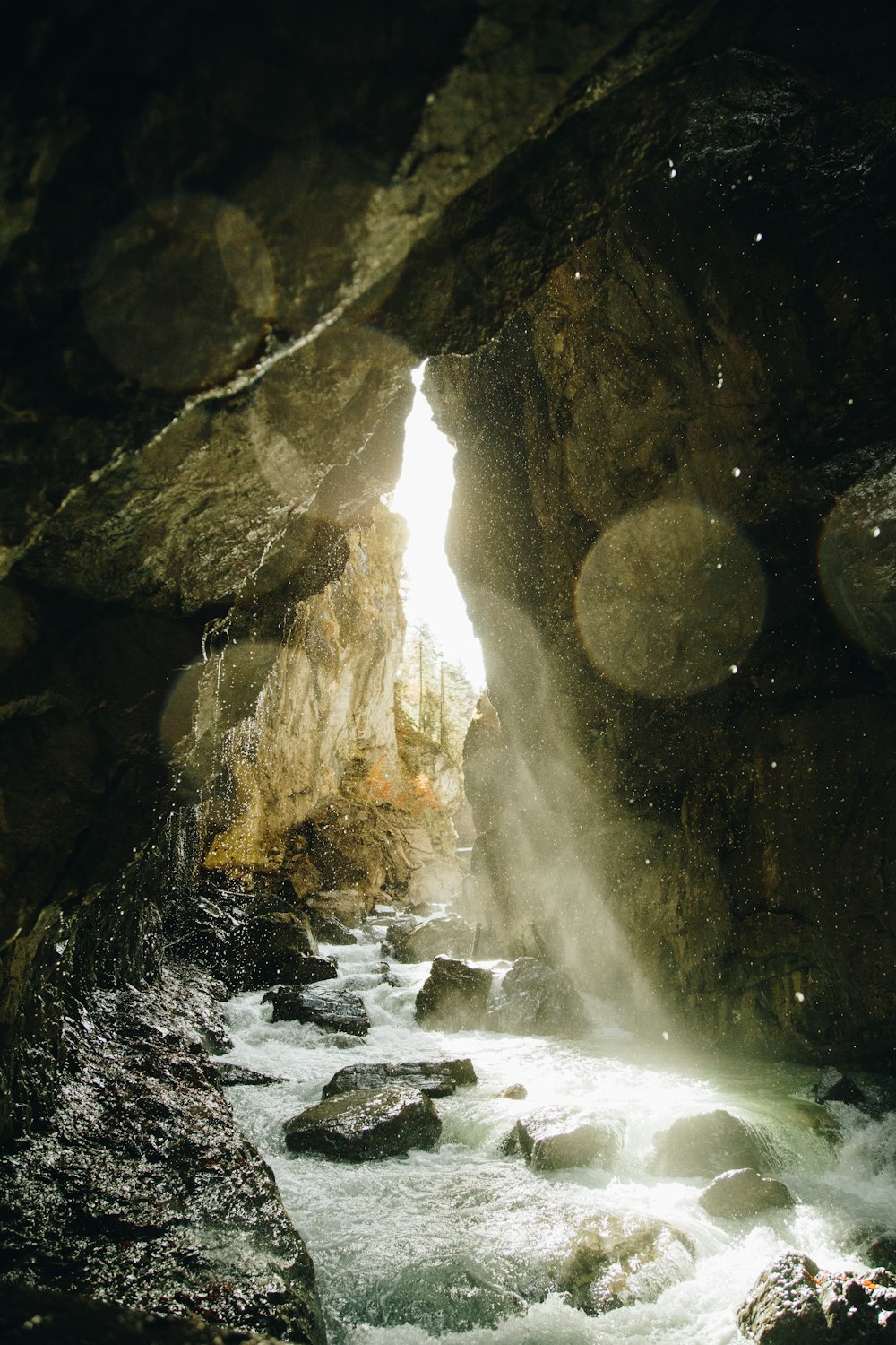 a stream running through a cave filled with rocks