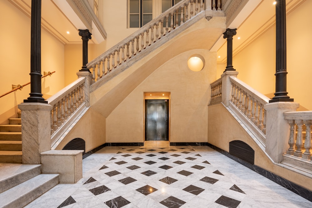 a hallway with a staircase and a tiled floor