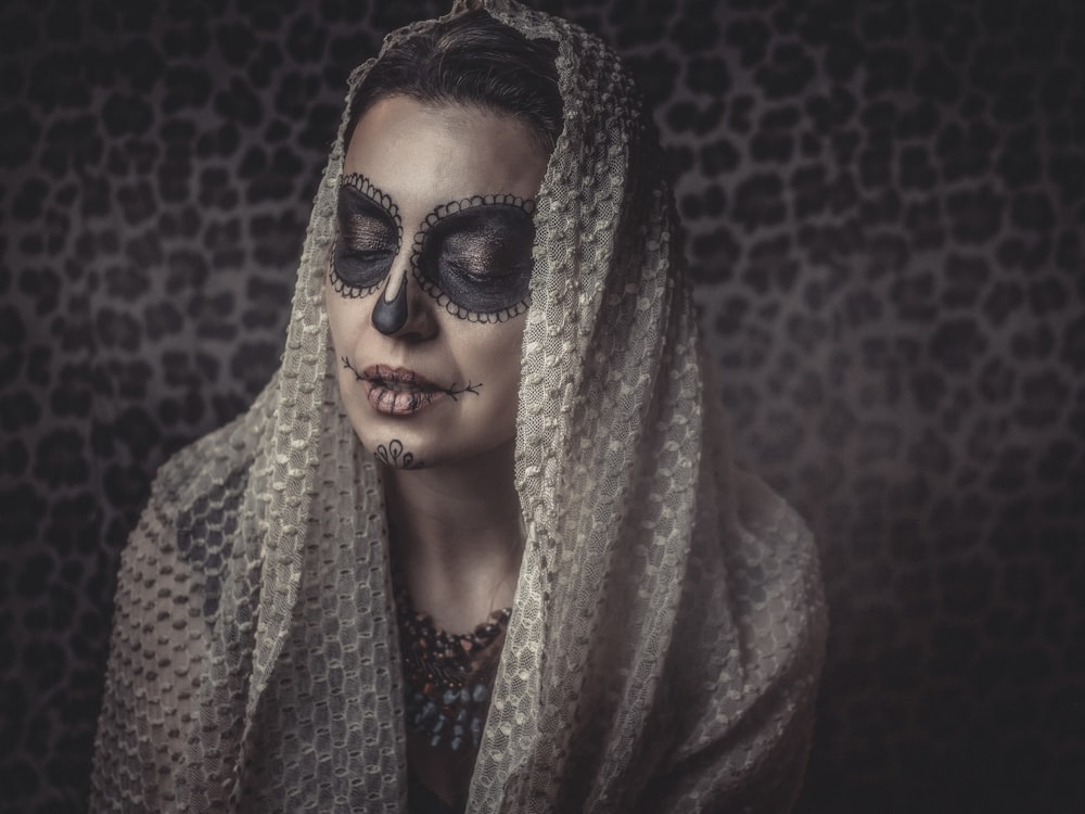 a woman with a skeleton make up on her face