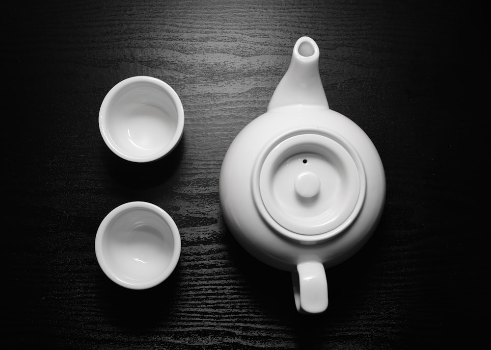 a black and white photo of a tea set