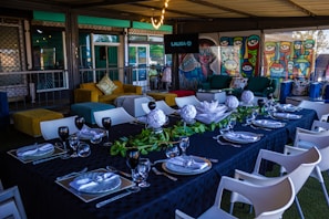 A beautifully set table featuring paella and Mediterranean decor.