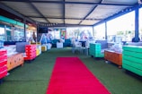 A commercial outdoor space featuring durable artificial turf with seating areas