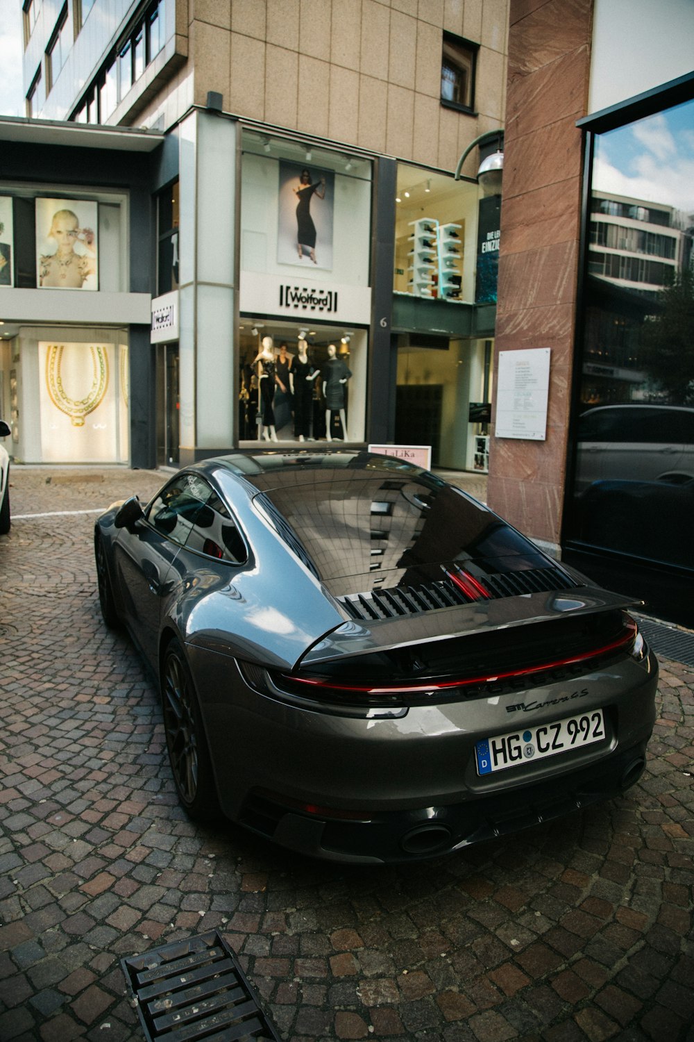 a black sports car parked in front of a building