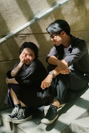 a man and a woman sitting on the steps