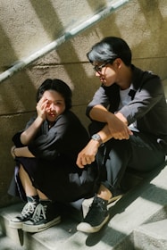 a man and a woman sitting on the steps