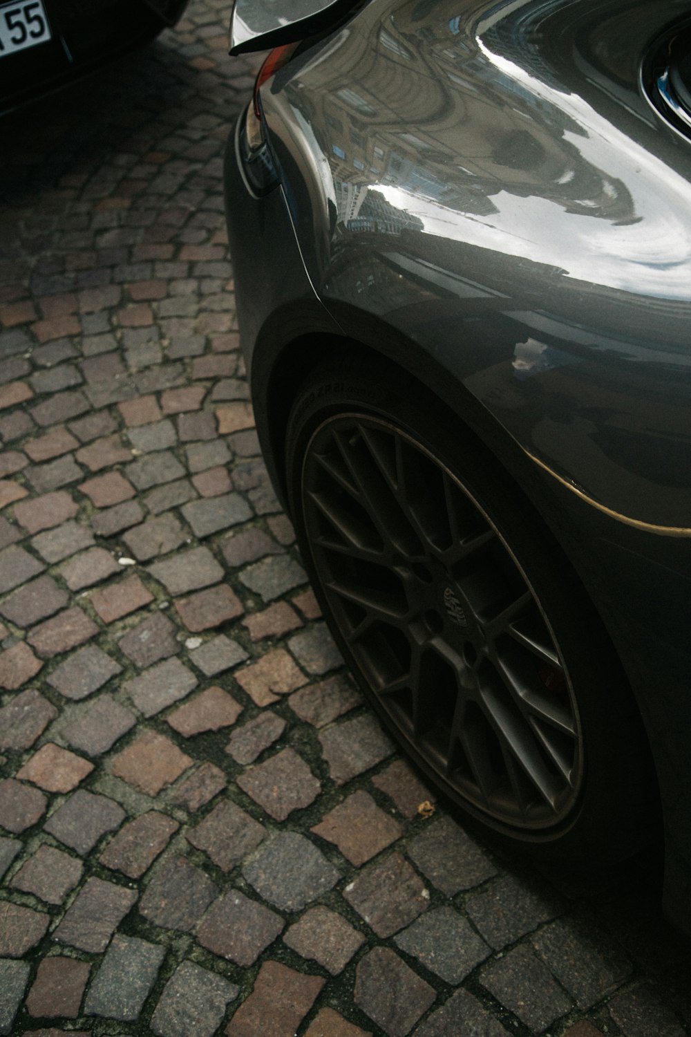 a close up of a car parked on a brick road