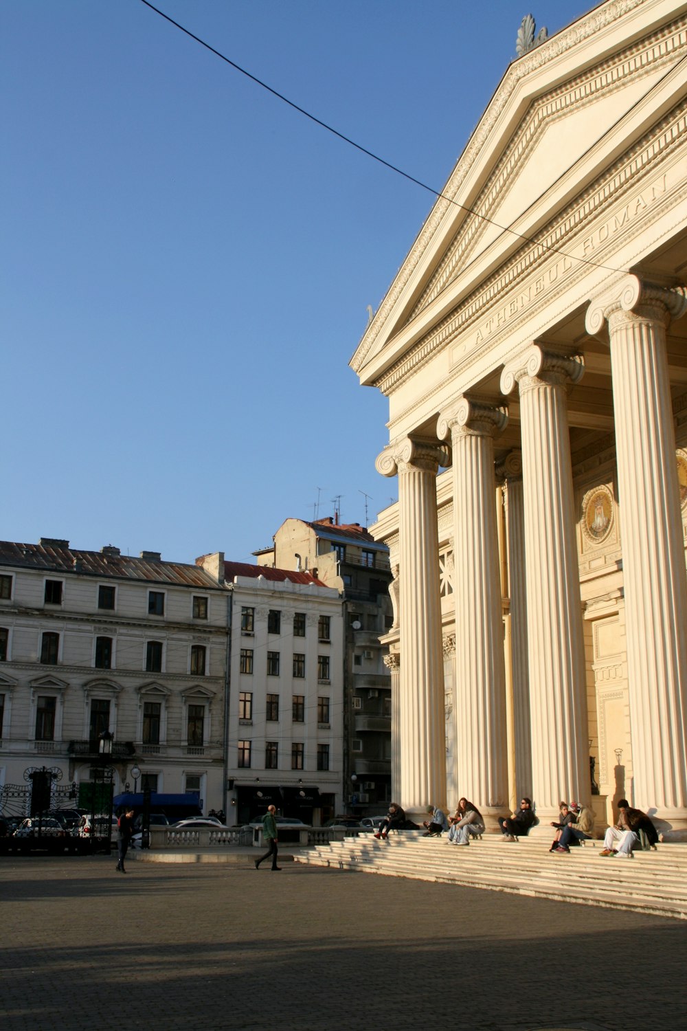 a group of people sitting on the steps of a building