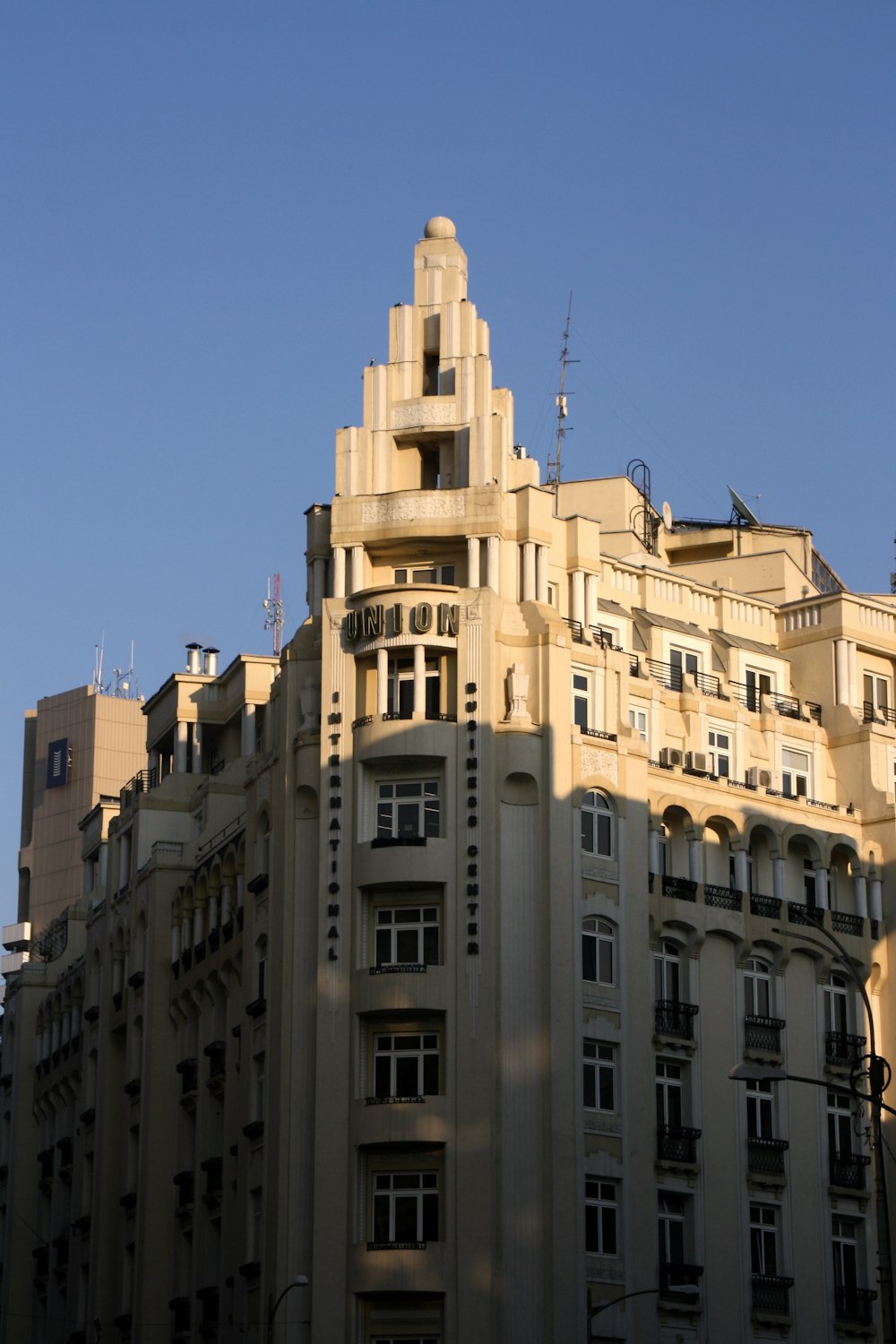a tall building with many windows and balconies