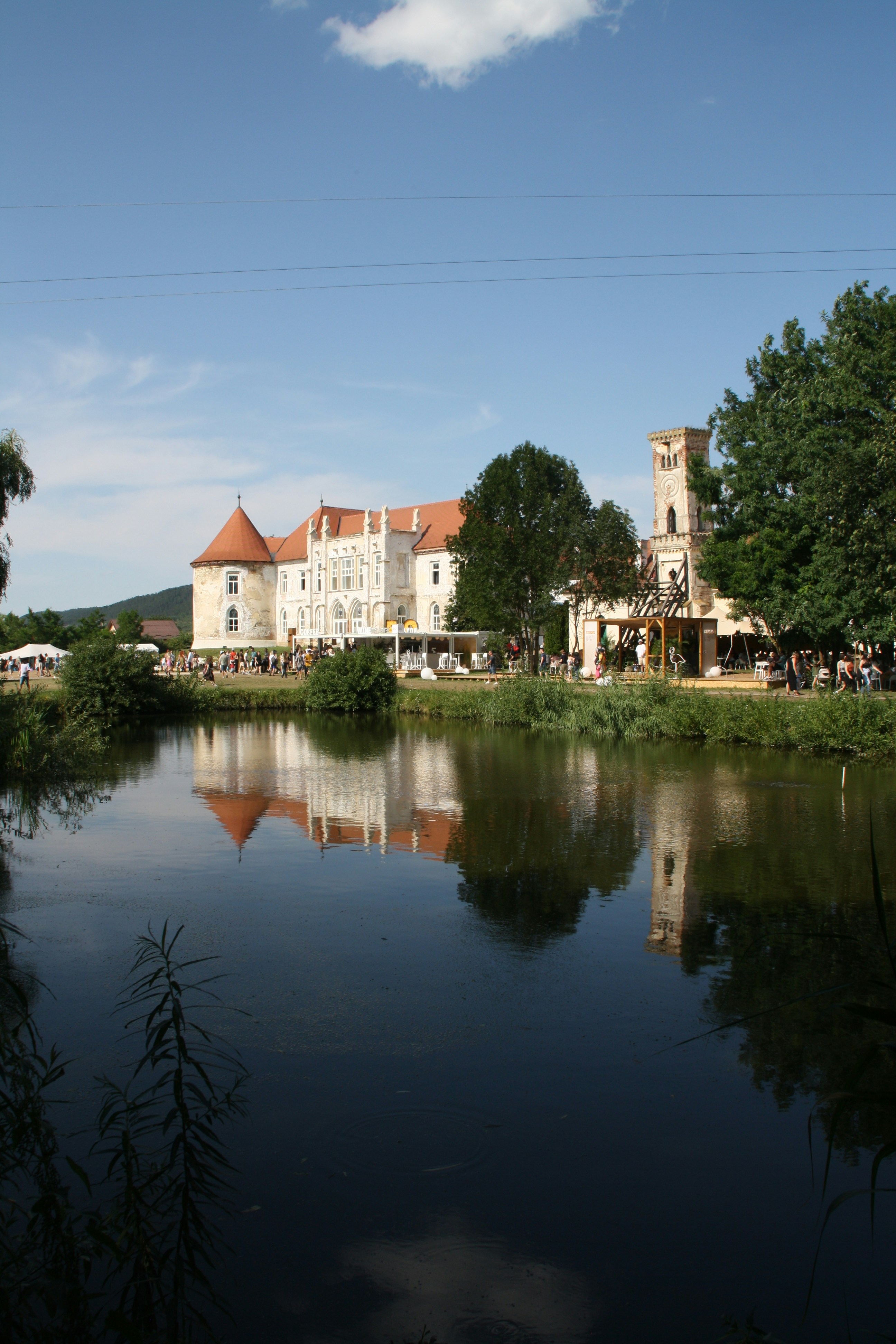 a large white building sitting next to a body of water