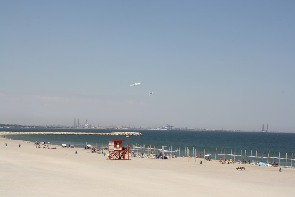 a view of a beach with a lifeguard tower in the foreground