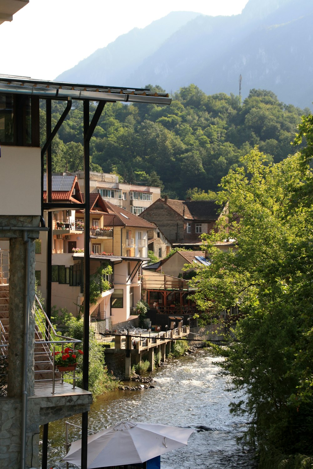 a river running through a small town surrounded by mountains